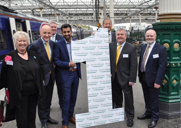MSP Christine Grahame, MP Calum Kerr, transport ministers Humza Yousaf, ScotRail boss Phil Vester, council leader David Parker and MSP Colin Beattie at the Borders Railway's first birthday party in Edinburgh in September.