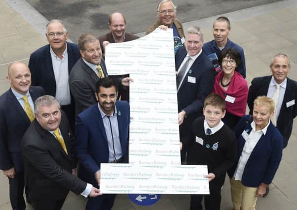 Transport minister Humza Yousaf, front centre left, at the Borders Railway's first birthday party in Edinburgh in September.
