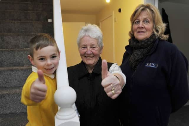 Ollie Turnbull, four, with his granny Anne Devine and housing association worker Elaine Brotherstone in Ollie's new home in Stonefield Place in Hawick.