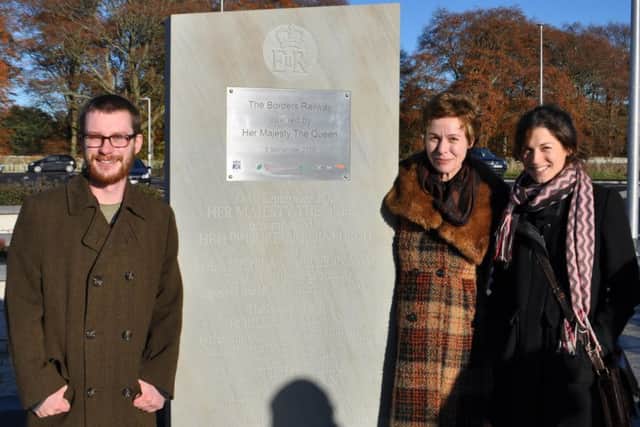 Luke Batchelor, Michelle De Bruin and Josephine Crossland with the stone at Tweedbank railway station.