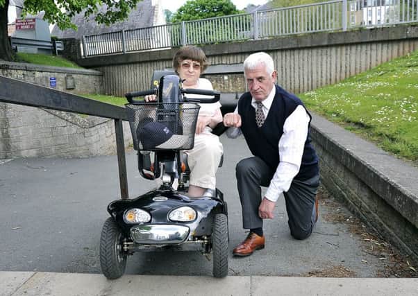 Iris Hutcheon and Cll. Jim Brown at the Jedburgh underpass which is unusable for wheelchairs due to the steps.