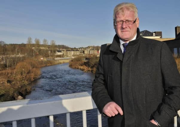 Councillor Stuart Marshall looking over the River Teviot a year on from the 2015 floods that caused havoc in Hawick.