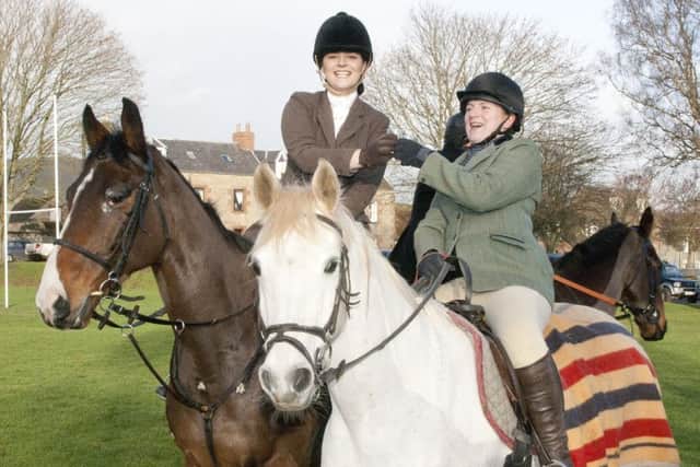 Bottoms up for Victoria Cuthbert and Serena Dale at the Denholm Hunt.