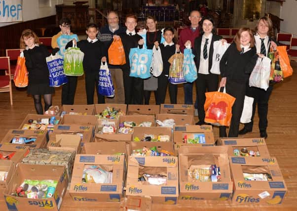 5TH YEAR PUPILS FROM EARLSTON HIGH SCHOOL WITH FOOD FOR THE FOOD BANK AT ST PAULS CHURCH IN GALASHIELS,THE TEACHERS AT THE BACK ARE ANDY SIMPSON AND JEN THOMSON BOTH RME TEACHERS ALSO THERE IS REV DUNCAN McCOSH