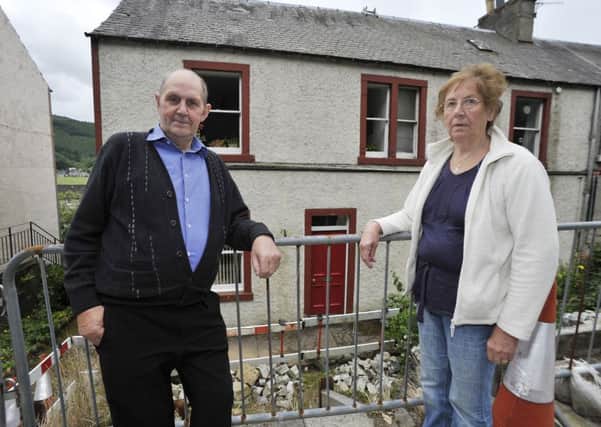 Sandy and Jane Glendinning are among the Walkerburn residents facing a hefty bill for repairs to the retaining wall.