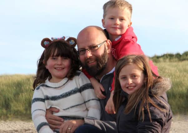 Andrew Slorance with younger children Olivia, left; Millie, right; and Finlay, top, on Iona.