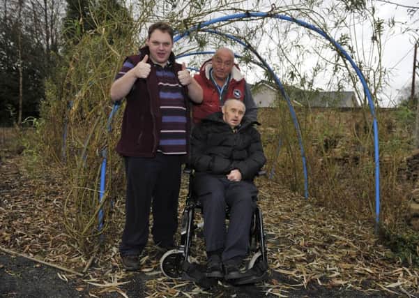 L-r, Jake Young, Stuart Toolan (carer) and Andy Knox of Cornerstone Connect in Galashiels who are receiving Â£12000 from Tesco to upgrade their garden.