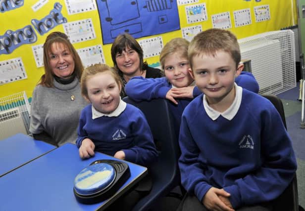 Maia Russell with her mum June Russell at Ancrum Primary School with her communication button which helps her in the classroom. L-r June Russell, Maia Russell, Sheila Munro (Aditional Needs Assitant), Freya Graham and Scott Humble (two of Maia's classmates who helped to raise the money for the button).