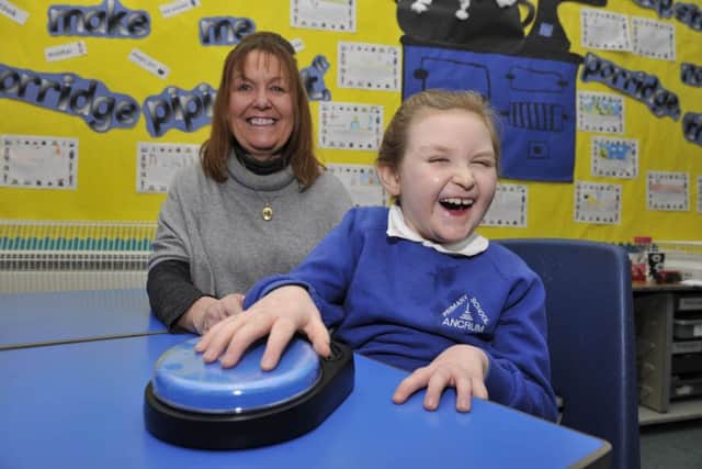 Maia Russell with her mum June Russell at Ancrum Primary School with her communication button which helps her in the classroom.