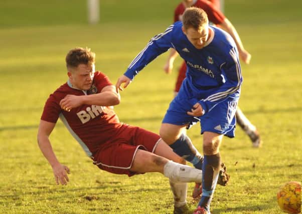 Challenging action between hosts Whitehill Welfare (in red) and Hawick Royal Albert (picture by Alan Wilson)