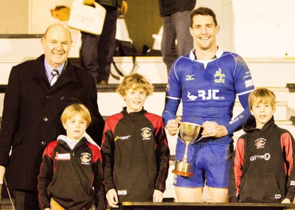 Kelso president Jim Hewit, with Kenneth Ballantyne's grandchildren, presents the cup to Jed captain Gregor Young (picture by Gavin Horsburgh)