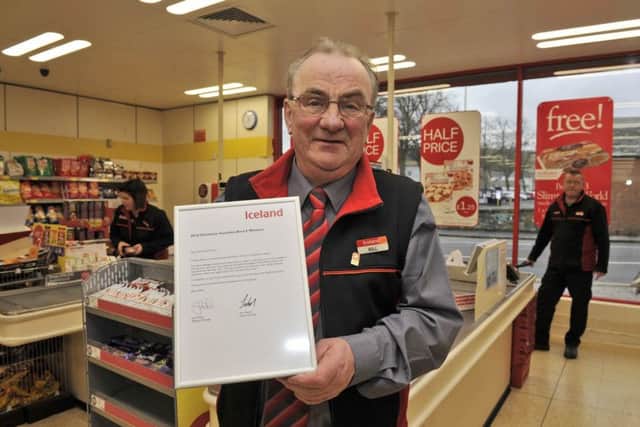 Hawick Iceland manager Bill Innes with the certificate won by the store's staff.