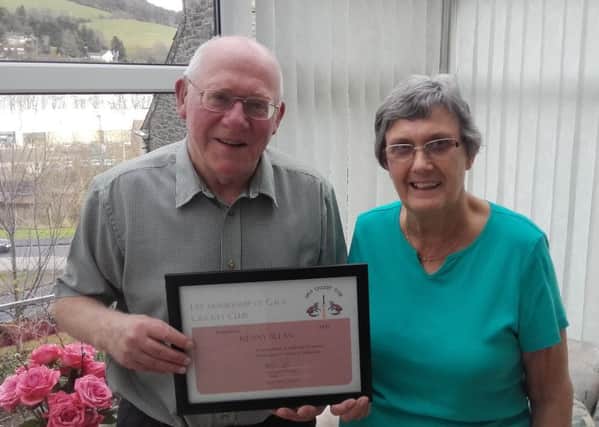 Kenny shows off his life membership certificate with his wife Irene.
