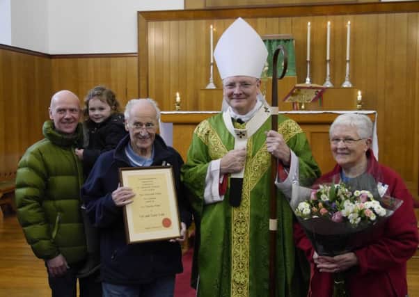 Archbishop Cushley along with Vic and Jane Law, their son, Gordon, and their granddaughter, Emma.