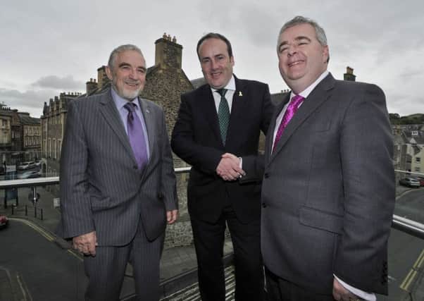 Scottish Government business minister Paul Wheelhouse, centre, in Hawick with Scottish Borders Council leader David Parker, right, and fellow executive member Stuart Bell in September when the funding was first announced.