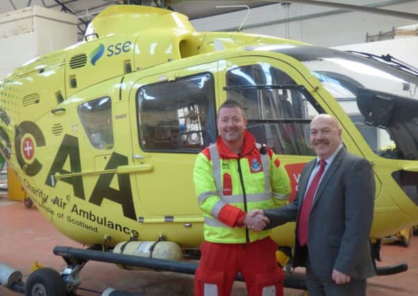 Martin Malone, NFU Mutuals regional manager for Scotland and Northern Ireland (right) with Scotlands Charity Air Ambulance paramedic Craig McDonald.