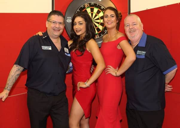Scotland duo Gary Anderson, left, and Robert Thornton with local walk-on girls, Marissa Sonkur of Hawick, left, and Lindsay Hogarth of Lauder (picture by Brian Sutherland
