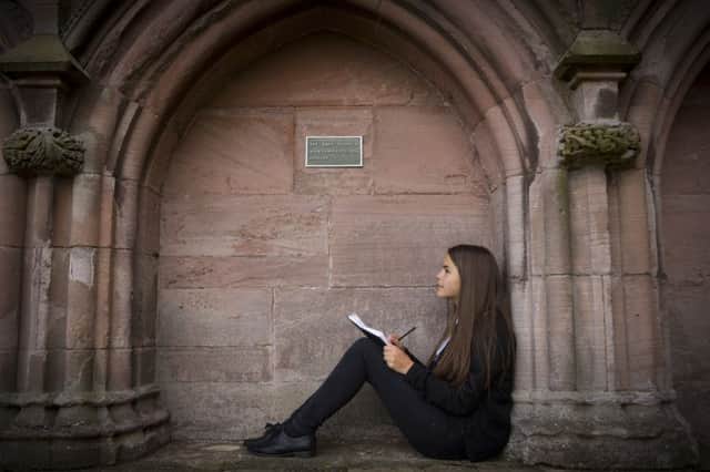 Ally Smith posing for Young Scott prize in Melrose Abbey.