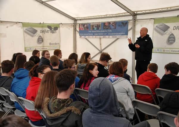 Chief Inspector Andy McLean briefs secondary school pupil at the young driver day at RAF Charterhall.