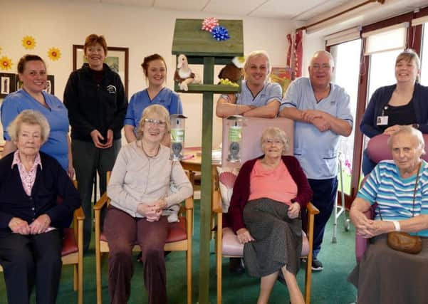 Volunteers at Borders charity Home Basics have produced a bird table for Hay Lodge Hospital in Peebles. Pictured with patients are Robyn Finney (staff nurse), Lorna Wilson (charge nurse), Kate MacDonald (Home Basics marketing co-ordinator), Michael Hay and Rod Sinclair (health care support workers) and Clare Harris.