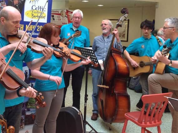 Riddell Fiddles performing outside Morrisons in Hawick.