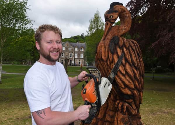 Sculptor Mark Hume with his heron sculpture in Wilton Lodge Park, Hawick.