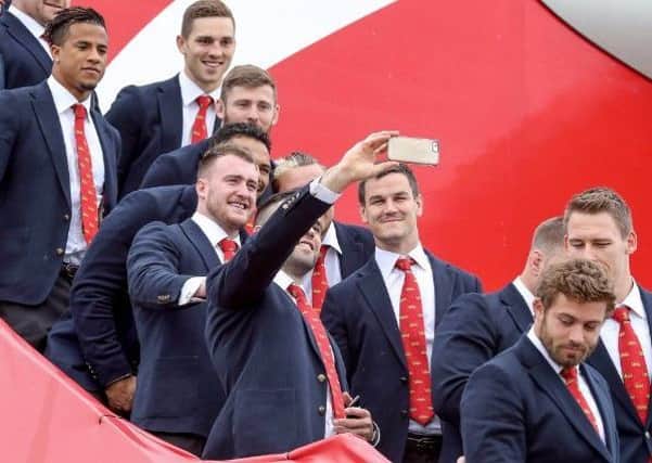 Stuart Hogg poses for some snaps with the rest of the Lions squad on the steps of the plane