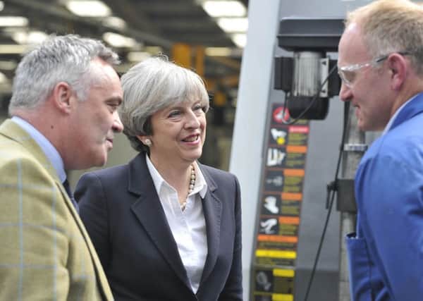 Prime Minister Theresa May visiting Abbey Gauge and Tools in Kelso today. Pictured here speaking to Adam Roxburgh.