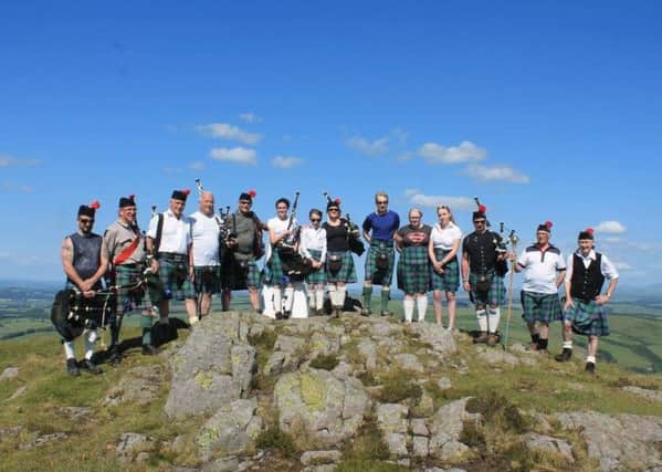 Hawick Scout Pipe Band play on top of Ruberslaw as part of the band's centenary celebrations.