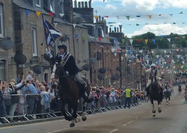 Braw Lad Greg Robertson and Braw Lass Amy Thomson in full flight up Scott St during today's rideout.
