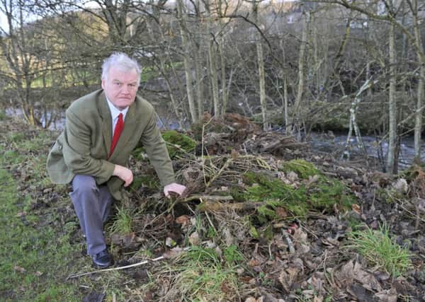 Hawick councillor Davie Paterson surveying green waste dumped in the town's Mansfield Road following the withdrawal of doorstep collections.