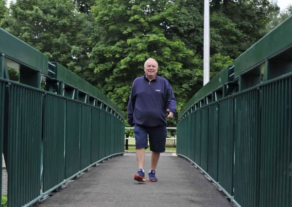Bobby Froud walks across the new bridge to Wilton Park as part of his daily walk of 10 miles to raise money for the Borders General Hospital.