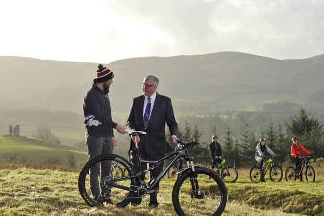 Scottish Government cabinet secretary Fergus Ewing with local mountain biker Gary Robertson at Glentress Forest in 2015.