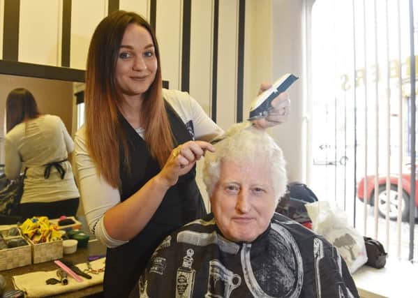 Luci Scott of TD9 barbers in Hawick with customer Tom Linden.