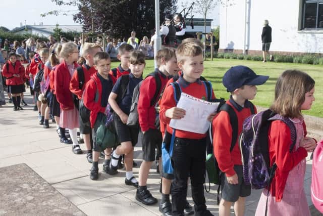 children filing into Duns new Primary school  bmcb 13