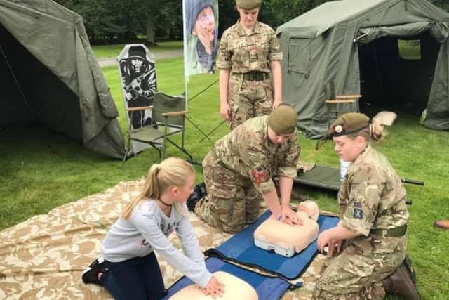 Army reservists give first aid demonstrations to youngsters.