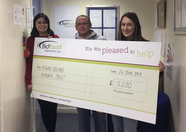 David Boland receives the cheque from Bidfood's Dawn Hastie (left) and Paige Gillie