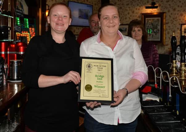Nikki Cassidy, left, being presented by Sarah Bellis with the Campaign for Real Ale's Scottish and Northern Irish pub of the year award for the Bridge Inn at Peebles.