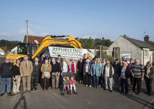 Villagers gathered to watch demolition work start on Newcastleton's old filling station.