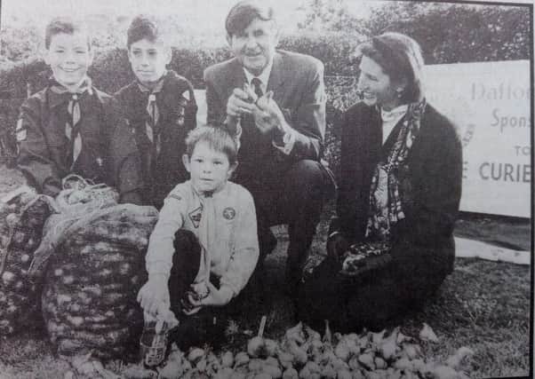 Bill McLaren and Lady Minto plant the first 100 daffodil bulbs for the Marie Curie Cancer Care "Field of Hope" in 1992.