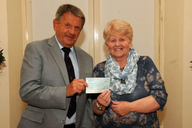 Jake Wheelans receives a cheque of Â£1,000 from Shiela Lockie, from the Selkirk Common Riding Booklet Committee. Photo: Grant Kinghorn.