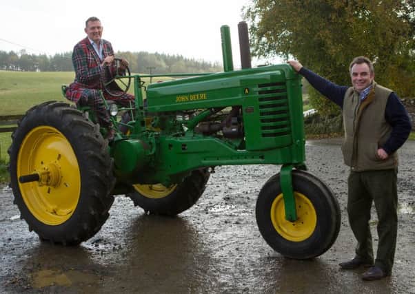Doddie Weir, left, with parade organiser Ross Montague and the John Deere Model A tractor to be auctioned off at Lauder on Sunday.