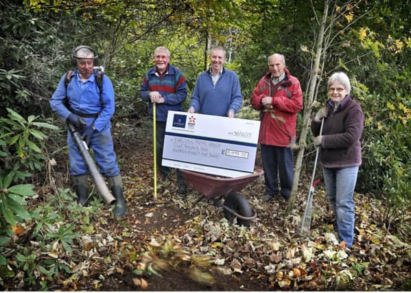 Fallago Environment Fund chairman Gareth Baird presenting a cheque for almost Â£8,500 to Earlston Paths Group members Tom McGhee, Bill Bryson, Ian Gibb and Ruth Gregory.