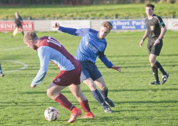David McCaughey, in blue, makes a challenge for Hawick Royal Albert (picture by Bill McBurnie).