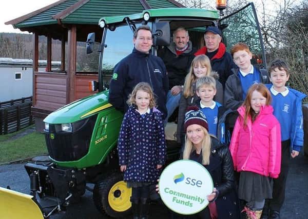 Oxton Community Council members taking delivery of the mini-tractor from supplier Thomas Sherriffs Ian Lauder, accompanied by SSEs Ciara Wilson and Channelkirk Primary School pupils, back in 2014.