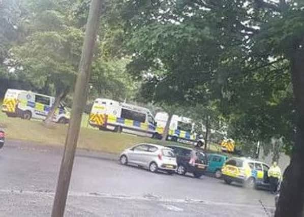 Police vehicles in Innerleithens Caddon Court area following the discovery of the body of a teenaged woman on Saturday.