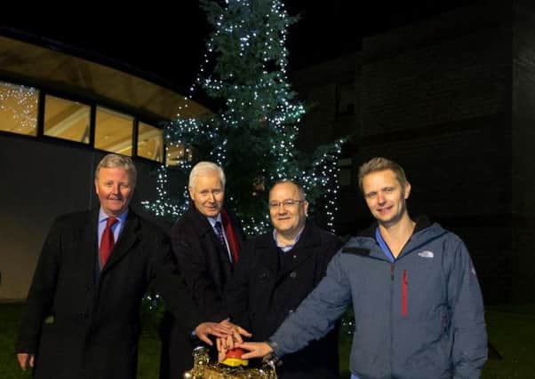 James Marjoribanks, John Raine, Richard Turnbull and James Torrie switching on last years tree of light at the Borders General Hospital.