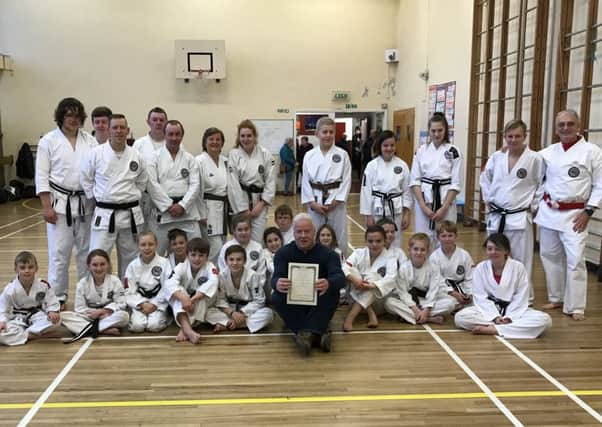 Martin, centre, displays his certificate, with Douglas Fowler (extreme right).