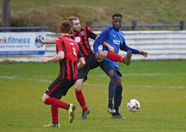 Ludovic Erhard, in blue, for Hawick Royal Albert, makes a challenge against Dalbeattie Star (picture by Stuart Cobley).