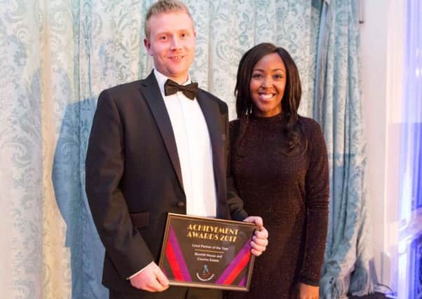 Rory Powell, a ranger at the Bowhill Estate in Selkirk, being given a Tomorrow's People award by Angellica Bell.